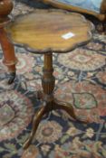 Reproduction wine table with shaped lobed top over a turned column and tripod base, top 30cm