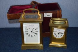 A carriage clock in case together with a smaller example