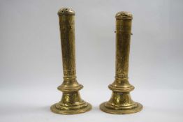 Pair of brass candle holders with covers with medieval designs, 25cm high