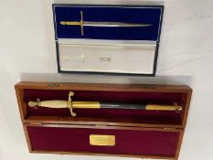 Cased Wilkinson presentation sword, set in a hardwood case bearing presentation plaque 'Presented to
