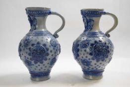 Two German Rhenish stone ware type ewers with applied blue decoration, 26cm high