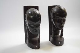 Two wooden African carved heads modelled as bookends, 25cm high