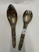 Pair of white metal silver salad servers with figural decoration, the reverse stamed acme Vancouver,