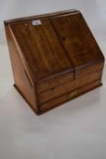 Victorian oak letter rack of wedge form fitted with hinged doors and a sub-divided interior, it