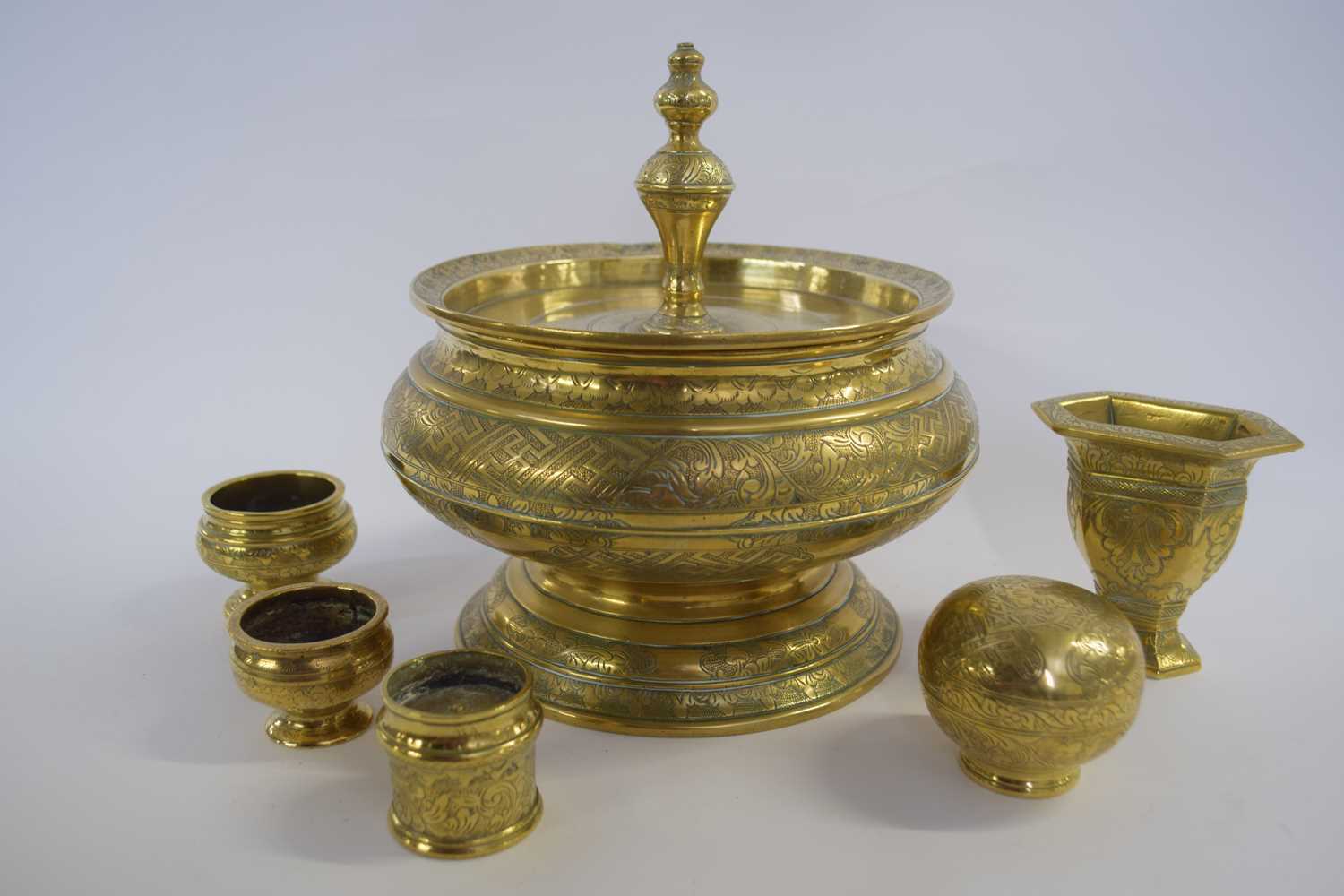 Balinese spice set comprising a large brass container and cover and other smaller implements
