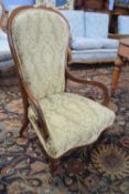 Victorian mahogany framed scroll armed chair raised on turned legs, 98cm high