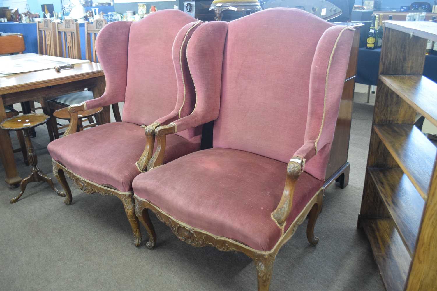 Pair of late 19th Century continental wing armchairs, upholstered in pink fabric raised on short