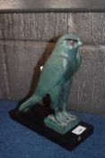 Patinated figure of an Egyptian God on retangular black wooden base