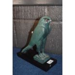 Patinated figure of an Egyptian God on retangular black wooden base