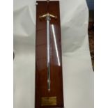 Large Wilkinson commemorative sword mounted on a polished hardwood back bearing presentation