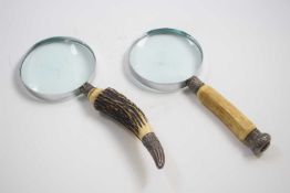 Two magnifying glasses with horn handles and silver collars, assay marks for Birmingham