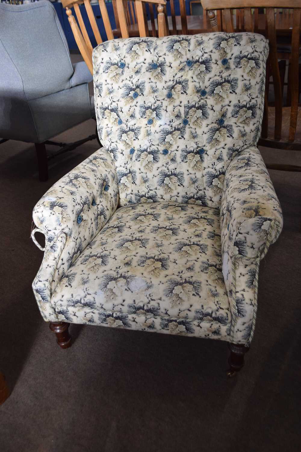 20th Century floral upholstered armchair set on turned legs with casters