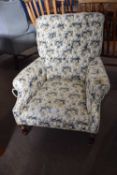 20th Century floral upholstered armchair set on turned legs with casters