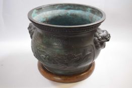 Large bronzed metal Chinese jardiniere decorated in relief with dragons and Chinese characters