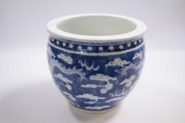 19th Century Chinese porcelain jardiniere, the blue ground decorated with dragons chasing the