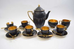 Carlton ware coffee set, the black ground with gilt handles and borders, the interior also gilt (one