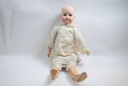 Late 19th early 20th Century doll with German bisque head in original clothing