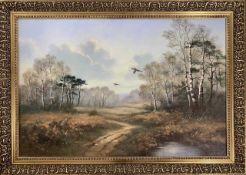 Wendy Reeves (British, 20th century), pheasants in flight over woodland, oil on canvas, signed, gilt