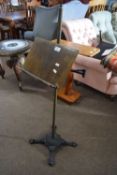 Unusual music stand with telescopic arm and a brass and cast iron stand with four outswept legs,