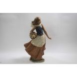 Lladro figure of a flower seller raised on an oval base, decorated in matt colours, 38cm high