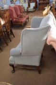 Large Georgian style wing back armchair raised on cabriole legs and a turned H stretcher, 107cm
