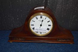A Swiss made Edwardian mantel clock, the white dial with black Roman numerals and with retailer