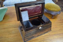 19th Century coromandel veneered tea caddy of sarcophagus form with a fitted hinged interior and