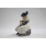 Royal Copenhagen model of a young girl seated on a bench sewing, 17cm high