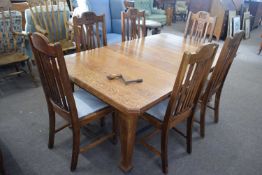 Late 19th Century oak extending dining table together with a set of six slat back dining chairs with