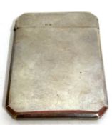 A George V silver card case of plain polished form having cantered corners and hallmarked Birmingham