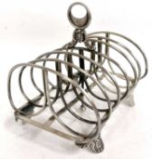 A large antique silver toast rack of rectangular form with six divisions and central carrying