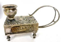 A vintage brass match box and chamber stick holder embossed with foliate scrolls etc, supported on