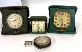 Mixed lot of travel clocks, three with display pouches and one without, also a small manually