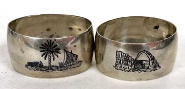 Two Middle Eastern white metal serviette rings decorated with Mosques, Dowhs etc, both with