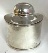 A Edward VII silver tea caddy and spoon of plain form with reeded edges, the domed hinged lid