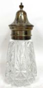 Cut glass and silver lidded sifter on a conical shaped cut glass body with pull off pierced lid,