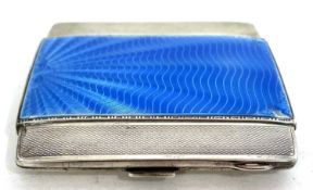 An Art Deco silver and enamel cigarette case, the front with applied with a shell blue guilloche