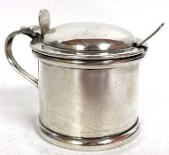 A George VI silver mustard of plain form the slight hinged dome lid opening to a blue glass liner