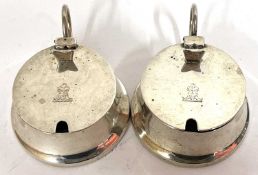 A pair of Edward VII silver mustards of circular squat form, the hinged lids engraved with lion