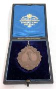 An antique bronzed golf medallion, entitled The County Golf Club, Port Rush, Co Anterim.