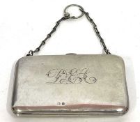 A George V silver card case of plain polished "bag" form, monogrammed, fitted interior with a