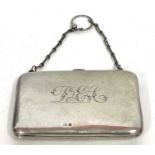 A George V silver card case of plain polished "bag" form, monogrammed, fitted interior with a