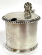 A George V silver drum mustard with gadrooned and reeded rims, shell thumb piece and blue glass