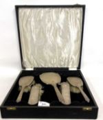 A cased Edward VII silver backed dressing table set comprising of mirror, two hairbrushes and two