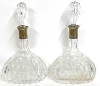 A pair of mallet shaped crystal decanters and stoppers having white metal collars, stamped 800, 23cm