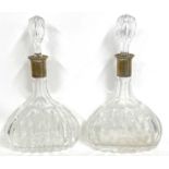 A pair of mallet shaped crystal decanters and stoppers having white metal collars, stamped 800, 23cm