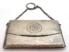 An Edwardian card case of evening bag form, spot hammered decoration, spring opening action,