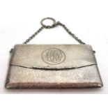 An Edwardian card case of evening bag form, spot hammered decoration, spring opening action,