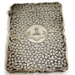 A late Victorian card case with wavy edges, engraved with a crest and monogram, having all over