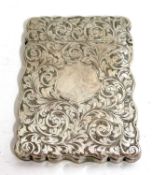 A late Victorian card case having wavey ridges and foliate engraved around a vacant cartouche,